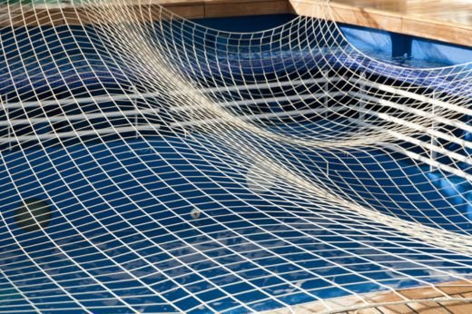 Durable swimming pool safety nets preventing accidental falls and ensuring a safe pool environment.